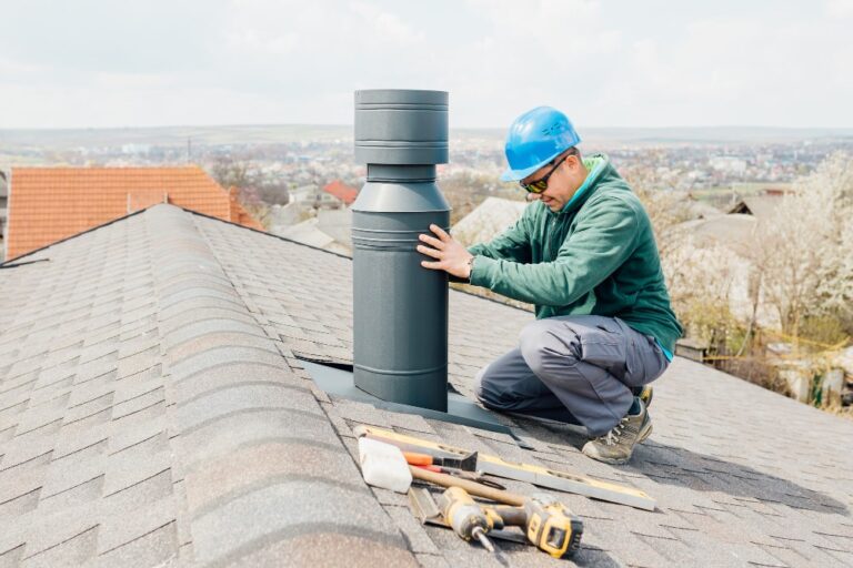 male-worker-with-blue-helmet-installs-iron-chimney-worker-min